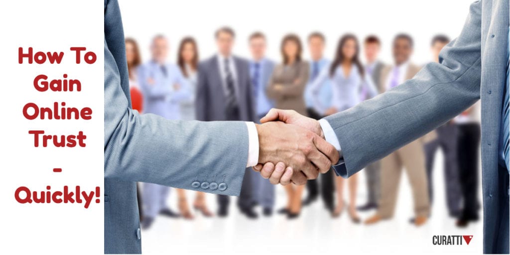 Business handshake. Others look on in the distance, blurred